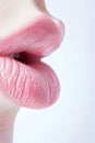 Close up view of beautiful woman lips with red lipstick on pink background. Open mouth with white teeth. Cosmetology Royalty Free Stock Photo