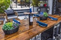 Close-up view of beautifully set wooden table at outdoor restaurant.