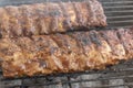 A close up view of beef spare ribs cooking on a Braai
