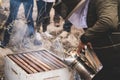 Beekeeper working with smoker at hive Royalty Free Stock Photo