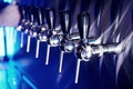 Close up view of beer taps in a pub. Artifical blue lighting Royalty Free Stock Photo