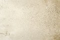 Close-up view of a beige concrete surface revealing small aggregate and subtle texture, ideal for backgrounds and design projects Royalty Free Stock Photo