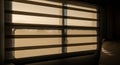 Close-up view of beige vertical blinds creating grid pattern shadows from sunlight streaming through a window in a dark room with Royalty Free Stock Photo