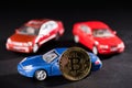 close-up view of bitcoin and car models Royalty Free Stock Photo