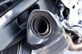 Close up view of a black carbon motorcycle exhaust pipe Royalty Free Stock Photo