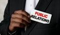 Close up view of a black man holding a business card. A young African businessman takes out a business card from the pocket of his Royalty Free Stock Photo