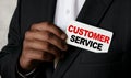 Close up view of a black man holding a business card. A young African businessman takes out a business card from the pocket of his Royalty Free Stock Photo