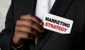 Close up view of a black man holding a business card. A young African businessman takes out a business card from the pocket of his Royalty Free Stock Photo