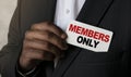 Close up view of a black man holding a business card. A young African businessman takes out a business card from the pocket of his Royalty Free Stock Photo