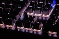 A close-up view of black mechanical pc keyboard with white backlight