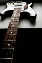 Close up view of black and white electronic guitar. Vertical low key photo Royalty Free Stock Photo
