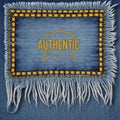 Blue denim patch with yellow stitching and fringe detail featuring the word A U T H E N T I C fabric Royalty Free Stock Photo