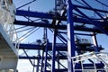 Close up view on blue gantry cranes operated by stevedores in horizontal position. Royalty Free Stock Photo