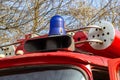 Close-up view of a blue light and fire hose on the roof of an antique fire engine Royalty Free Stock Photo