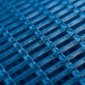 A close-up view of a blue mesh structure with a grid pattern. The intersecting Royalty Free Stock Photo