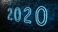 Close up view of blue neon light 2020 number on an old red brick wall. New Year Royalty Free Stock Photo