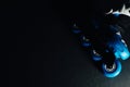 Close up view of blue roller skates inline skate or rollerblade on dark tinted grunge backgroung Royalty Free Stock Photo