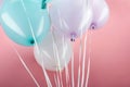 Close up view of blue, white and purple colorful balloons on pink background. Royalty Free Stock Photo