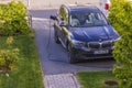 Close up view of BMW ix3 electric car with charging cable in a private parking lot.