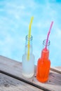 close-up view of bottles with summer beverages and drinking straws Royalty Free Stock Photo
