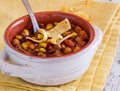 Close up view of a bowl of chili con carne garnished with corn chips. Royalty Free Stock Photo