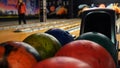 Close-up view of bowling player hand taking colorful ball from bowl lift. Media. People playing bowling - the bowling