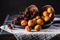 close up view of bowls with cherries and apricots on tray on wooden Royalty Free Stock Photo