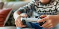 Close up view of boy sitting on sofa with gamepad and playing video games. Child having fun at home. Concept of gaming Royalty Free Stock Photo