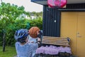 Close-up view of boy throwing ball at basketball hoop in garden of villa. Royalty Free Stock Photo