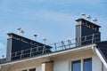 Close-up view of brick stone pipe covered with metal sheets and a black smoke box on roof. Ventilation pipe on roof of modern Royalty Free Stock Photo