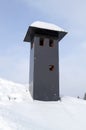 close-up view of brick stone pipe covered with metal sheets and black smoke box on snowy roof at winter Royalty Free Stock Photo