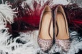 close up view of bridal shoes and decorative feathers