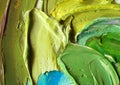 Close-up view of bright paint layered thickly. Strokes of paint