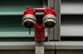 Close-up view of a bright red fire hydrant standing atop a concrete sidewalk in a suburban area
