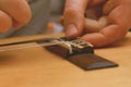 Close up view on broken string repair on acoustic guitar