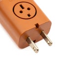 Close-up of a brown electrical adapter with US plug prongs and a universal socket power Royalty Free Stock Photo