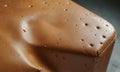 close-up view brown leather surface with small holes, possibly from leather bag or case, with textured and