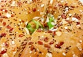 Close up view of brown seeded bagel with green rocket