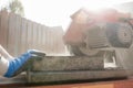 Close up view of a building contractor using an angle grinder or Royalty Free Stock Photo