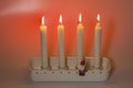 Close up view of burning candles Christmas in honor of fourth advent isolation on red background. Royalty Free Stock Photo