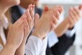 Close up view of business seminar listeners clapping hands