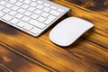 Close up view of a business workplace with wireless computer keyboard, keys and mouse on old dark burned wooden table background. Royalty Free Stock Photo