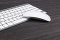 Close up view of a business workplace with wireless computer keyboard, keys and mouse on old dark wooden table background. Office Royalty Free Stock Photo