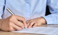 Close up view of businesswoman hand signing paper document with ballpoint. Royalty Free Stock Photo