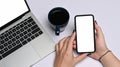 Businesswoman sitting at her office desk and using mobile phone. Royalty Free Stock Photo