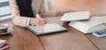 Close-up view of businesswoman using mock-up tablet while working on her project in comfortable workspace Royalty Free Stock Photo