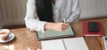 Close-up view of businesswoman working on her project while typing on blank screen digital tablet Royalty Free Stock Photo