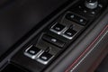 Close up view of button controlling window in modern car interior. Vehicle interior detail. Royalty Free Stock Photo