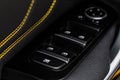Close up view of button controlling window in modern car. Vehicle interior detail. Door handle with windows controls Royalty Free Stock Photo