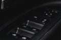 Close up view of button controlling window in modern car interior. Vehicle interior detail. Royalty Free Stock Photo